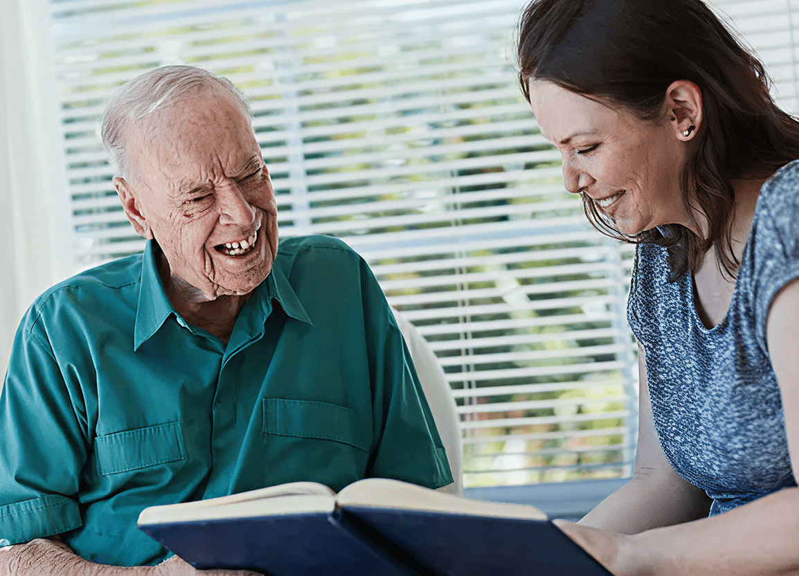Elderly man and woman reading a book.